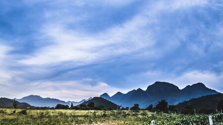 Mountain landscape with a dawn,Cute rural landscape tree, field, mountains . landscape of mountains and meadow .Prachubkeereekhan Thailandの写真素材