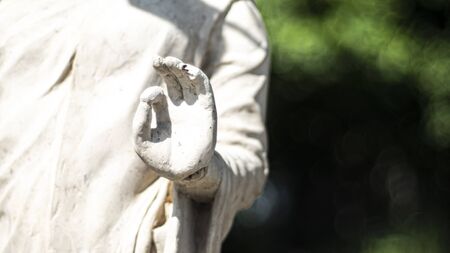 Statue of Buddha standing in meditation.Close up hand of statue Buddha.buddhism concept .peacefulness idea .lifestyle practise mind in clamnessの写真素材