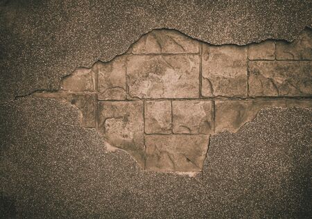 Big crack in old messy concrete wall . cracked concrete wall covered with gray cement surface as background . old shabby concrete and brick cracks. Vector separate elements for wall decor.a holeの写真素材
