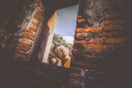 Wat Phutthaisawan Reclining Buddha in Ayutthaya Thailand. heritage destination . view through window ruins of acient temple.travel and exploration culture in Asiaの写真素材