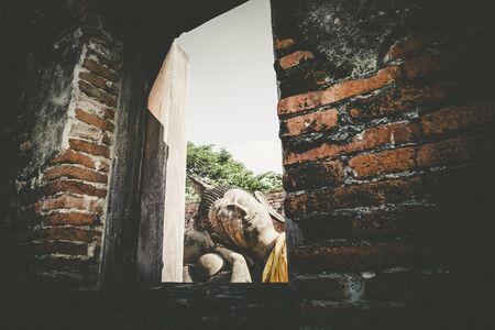 Wat Phutthaisawan Reclining Buddha in Ayutthaya Thailand. heritage destination . view through window ruins of acient temple.travel and exploration culture in Asiaの写真素材