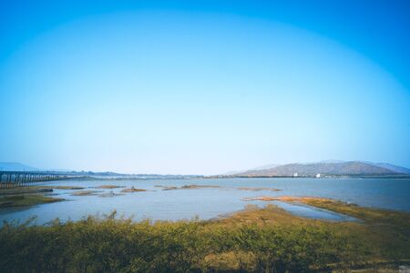 Panorama of lake landscape in Thailand with railway across the lake and mountain scene on background  against summer blue sky in Lopburi province Pa Sak Jolasid Damの写真素材