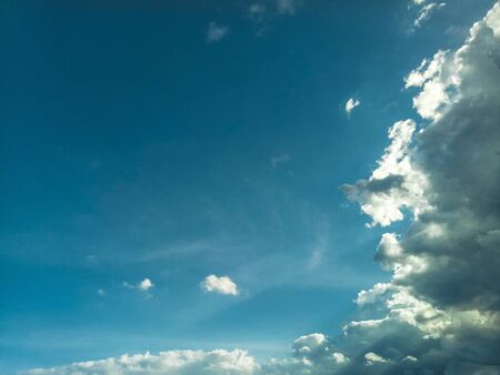 beautiful sky cloudscape .rim light behind dark cloud with blue sky backgroundの写真素材