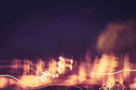 Long exposure photography of Light painting light trails at night by slow shutter technique. Speed of movement of abstract background in dark night light lines with long exposure. Bright highlightsの写真素材