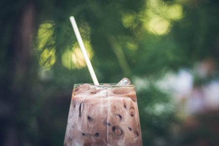 Close up summer refreshment drinks. Chilled iced chocolate cocoa. Chocolate powder and ice. In...