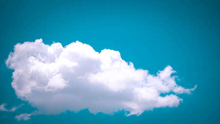 Heart shaped gate decorate with purple p A single fluffy white cloud against a blue sky ink and green bougainvilleaの写真素材