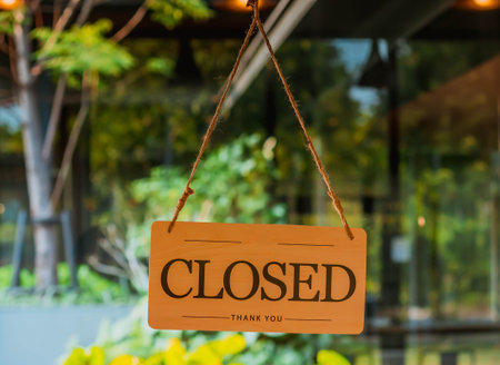 closed sign on door entrance cafe restaurant or business office store is closed due to the effect of...