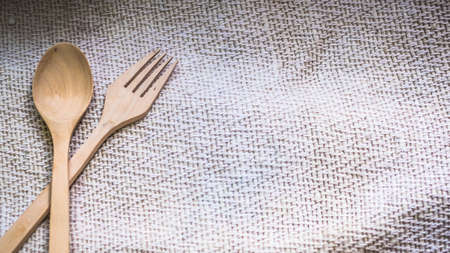 wooden spoon and fork on sack bag background with copyspaceの写真素材
