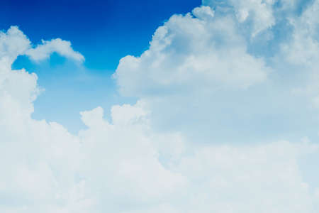 White fluffy clouds against blue sky in summer nature season weather backgroundの写真素材