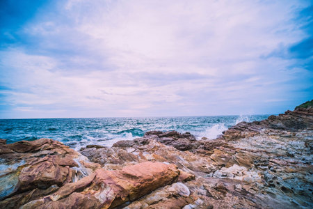 Sea Ocean with Smooth Wave and Rock landscape with blue sky. Nature of Seascape vacation time.