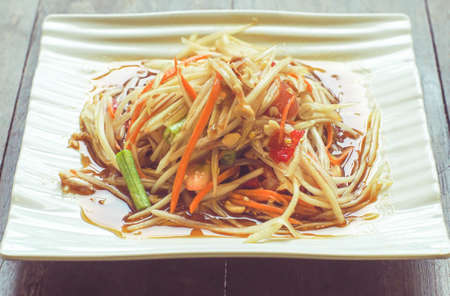 Som tum Thai best dish is vegetarian papaya spicy salad food in Thailand. Ingredient are vegetable lemon tomato papaya lime shrimp.の写真素材