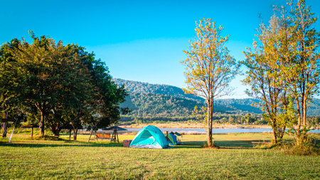 Pyramid Tent Camping Tent in Blue among forest nature with mountain against blue sky in background at Khaoyai Thailandの写真素材