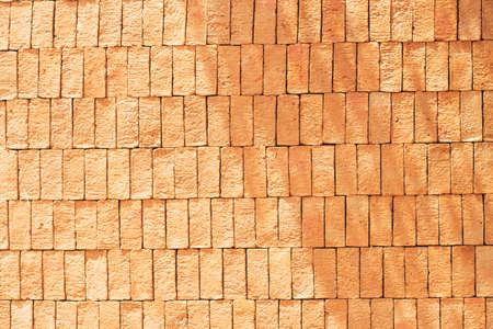 Rectangular orange bricks random pattern wall facade texture material in architecture exterior and interior.の写真素材