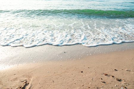 Close Up Wave Sand Beach Sea Foam.  Closeup of sea wave with foam on beach sand. Vacation Summer backgroundの写真素材