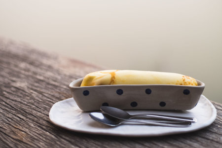 Banana crepe sweet dessert object still life. The crepe put in the ceramic container bowl banana shape form design.の写真素材