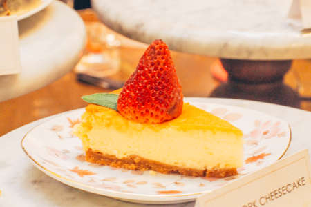 Slice of delicious single strawberry dressing on top  cheese cake on vintage plateの写真素材