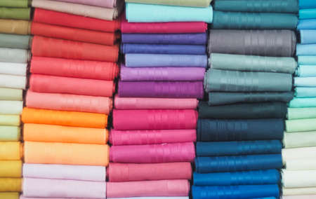 colorful fabric rolls in textile shop industry.Rolls of bright colored fabricの写真素材