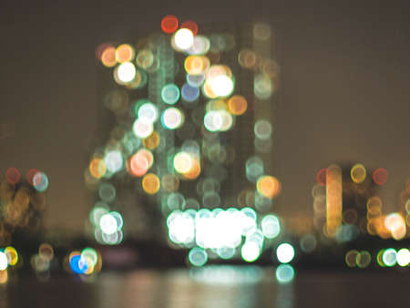 Bokeh city lights background. Bokeh of cityscape skyline during evening dark blue sunset, dusk twilightの写真素材