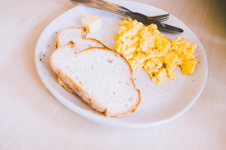 Mascarpone Scrambled Eggs with Garlic Toasts food breakfast meal in ceramic plate disk.の写真素材