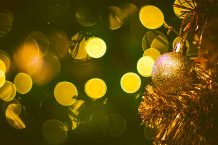 Christmas ball decoration on yellow background. Colorful blur bokeh background. christmas backgroundの写真素材