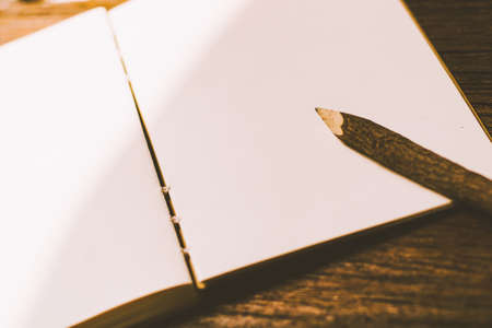 a nature wood pencil on a clean piece of white paper book.の写真素材