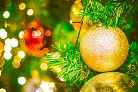 Christmas ball decoration on yellow background. Colorful blur bokeh background. christmas backgroundの写真素材