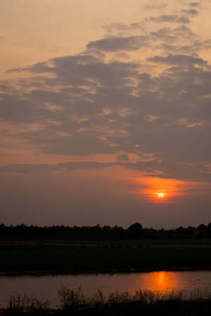 Dramatic  sunset landscape with dark  sky, silhouettes of trees and lake. sky of lake landscapeの写真素材