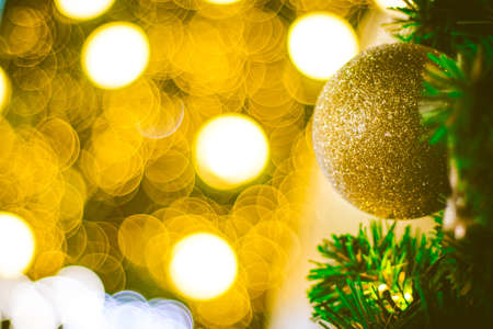 Christmas ball decoration on yellow background. Colorful blur bokeh background. christmas backgroundの写真素材