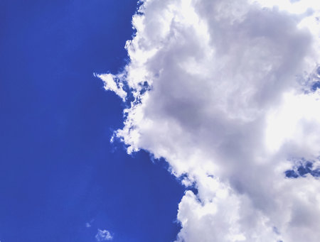 Huge white fluffys clouds sky background with blue sky backgroundの写真素材