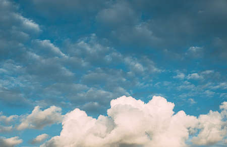 Huge white fluffys clouds sky background with blue sky backgroundの写真素材
