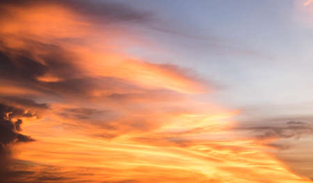 Beautiful sunset sky above clouds orange sunset sky. Beautiful sky. Dramatic red yellow pastel color at sunset.の写真素材