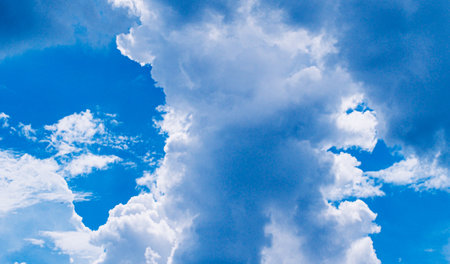 white fluffy clouds sky background with blue sky background for copy space.の写真素材