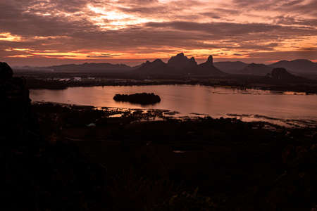 Panorama dramatic silhouette mountain landscape at sunset in the sea.の写真素材