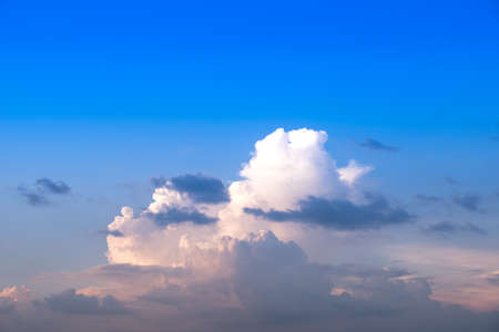 Huge white fluffys clouds sky background with blue sky backgroundの写真素材