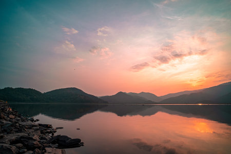 Panorama scenic of mountain lake with perfect reflection at sunrise. beautiful mountain range...