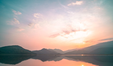 Panorama scenic of mountain lake with perfect reflection at sunrise. beautiful mountain range...
