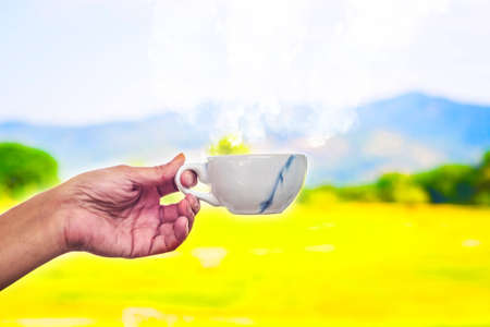 Morning cup of coffee on the against the backdrop of mountain landscapeの写真素材
