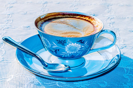 Milk tea or latte coffee with milk in blue vintage cupの写真素材