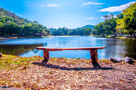 empty park benchon Lake Nipissing during a beautifully colourful springの写真素材