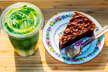 bownie cake on flower pattern vintage plate serve with and Green tea Latteの写真素材