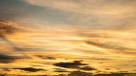 Dramatic clouds at sunset with cityscape silhouette. Abstract season weather vacation time.の写真素材