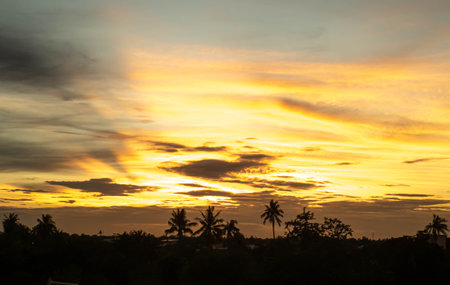 Dramatic clouds at sunset with cityscape silhouette. Abstract season weather vacation time.の写真素材