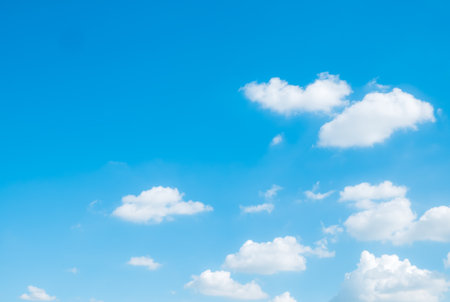 white fluffy clouds sky background with blue sky background for copy space.の写真素材