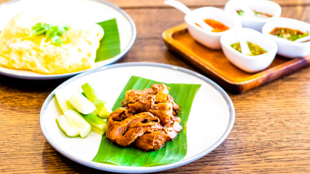 Thai food Fried Pork on banana leaf with Garlic Rice and vegetableの写真素材
