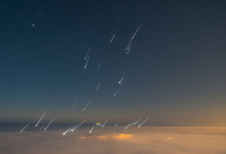 A stunning display of shooting stars streaking through delicate, glowing cirrus clouds, illuminating the night sky with brilliance.の素材