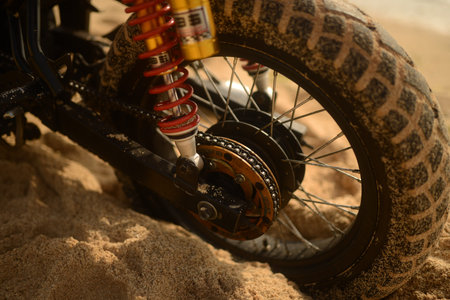 Manly photo of strong motorcycle in yellow sand on the tropical beach  in Bali