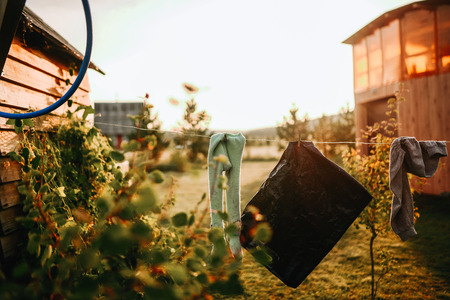 atmospheric outdoor photo of family life with drying clothes on a rope in the yard of home in the morning in the villageの写真素材