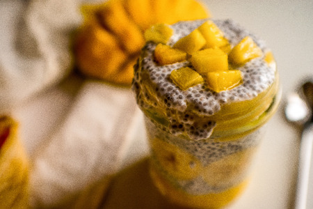 Beautiful photo of chia pudding with babana,  mango and coconut milk on the breakfastの写真素材