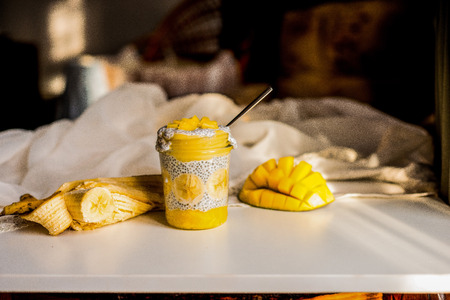 Beautiful photo of chia pudding with babana,  mango and coconut milk on the breakfastの写真素材