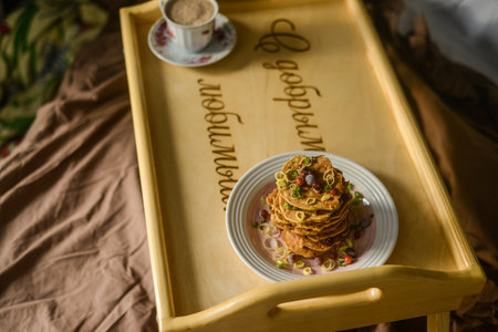 Very appetizing beautiful food photo of tasty breakfast in bed from eastern pancakes and cup of...